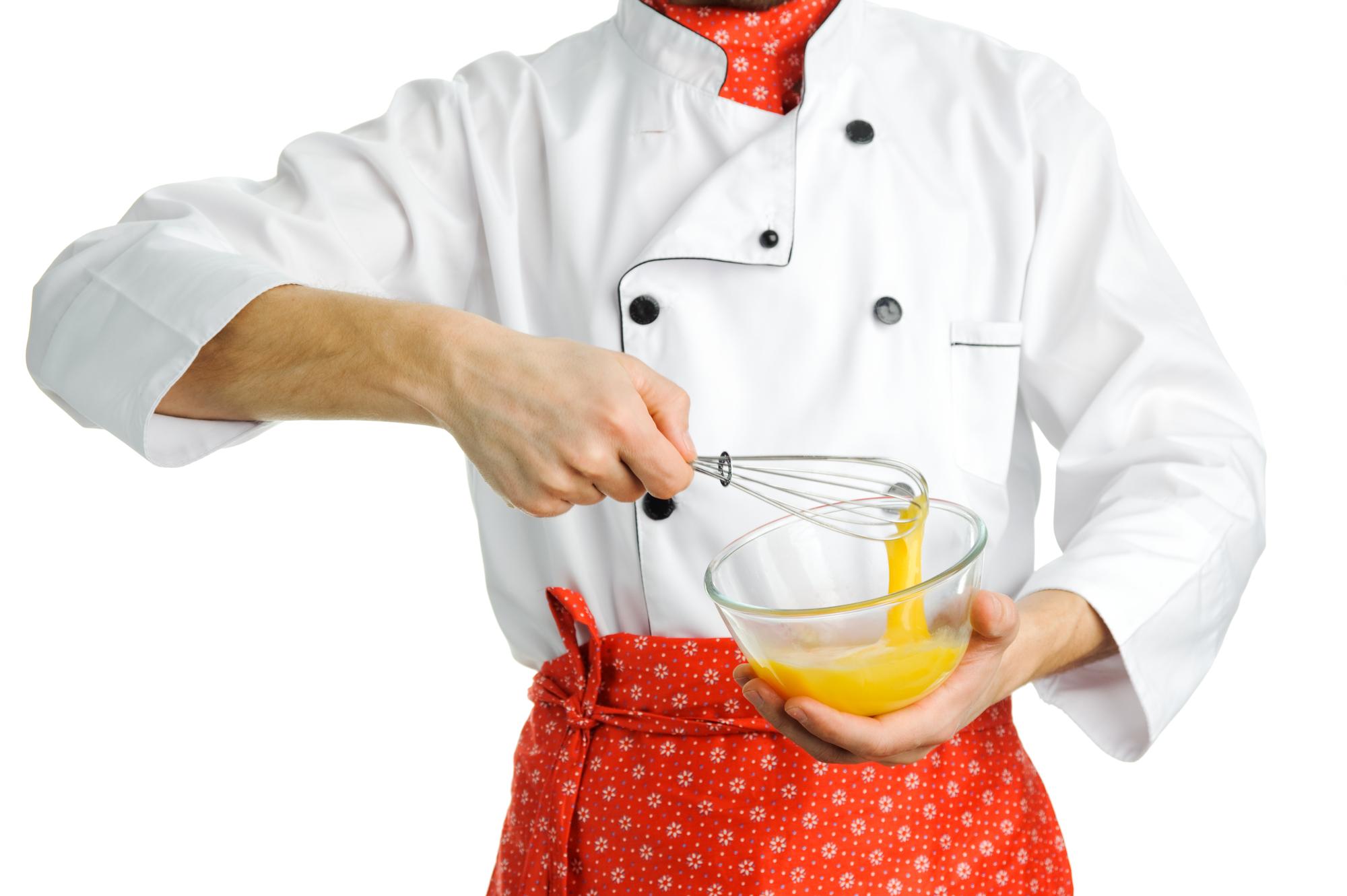 Chef demonstrating technique in bright kitchen